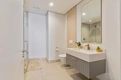 a bathroom with a sink and a toilet at Premium Urban Retreat at Ellipse Waterfall in Midrand