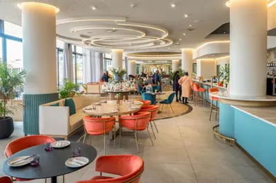 a restaurant with tables and chairs and a bar at Premium Urban Retreat at Ellipse Waterfall in Midrand