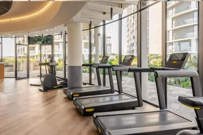 a gym with rows of treadmills in a building at Premium Urban Retreat at Ellipse Waterfall in Midrand