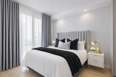 a bedroom with a large bed and a window at Premium Urban Retreat at Ellipse Waterfall in Midrand