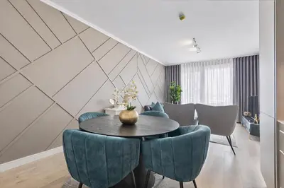a dining room with a table and blue chairs at Premium Urban Retreat at Ellipse Waterfall in Midrand