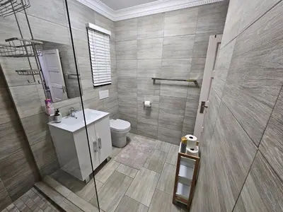 a bathroom with a shower and a toilet and a sink at A Pearl Place in Pretoria