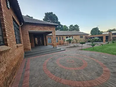 a brick building with a brick circle in front of it at A Pearl Place in Pretoria