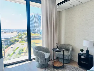 a room with two chairs and a large window at Ellipse Waterfall in Midrand