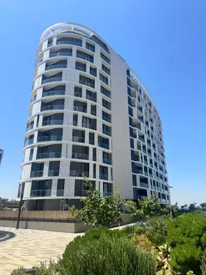 a tall apartment building with a blue sky in the background at Ellipse Waterfall in Midrand
