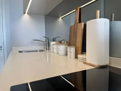 a kitchen counter with a sink and a roll of paper towels at Ellipse Waterfall in Midrand