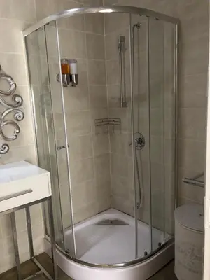 a shower with a glass door in a bathroom at Studio at 26 in Centurion