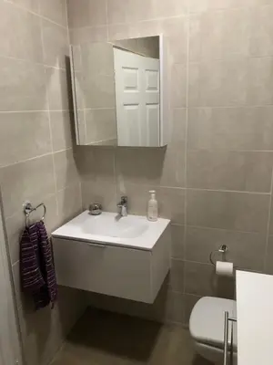 a bathroom with a white sink and a mirror at Studio at 26 in Centurion