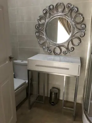 a bathroom with a white sink and a mirror at Studio at 26 in Centurion