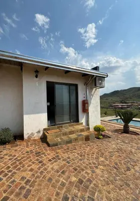 a house with a patio and a swimming pool at JandJ Guest House in Armburg
