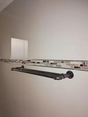 a glass shelf on a wall in a room at JandJ Guest House in Armburg