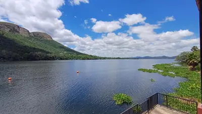 a view of a lake with mountains in the background at Boathouse 203 in Hartbeespoort