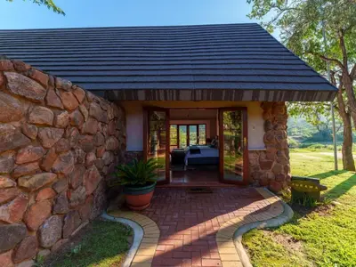 a stone house with a stone wall at Thaba Metsi Private Game Lodge - Welgevonden in Vaalwater