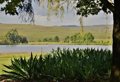 a view of a lake with mountains in the background at LINGER LONGER COUNTRY RETREAT, Dullstroom in Dullstroom