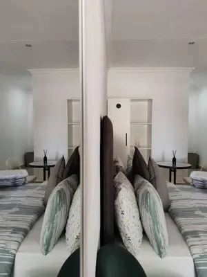 a bedroom with a bed with pillows on it at Golf B&B in Nelspruit