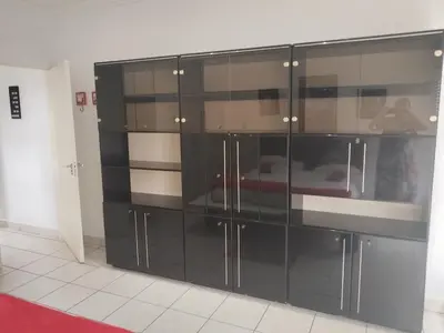 a large black cabinet with glass doors in a room at Elephant hide away in Witbank