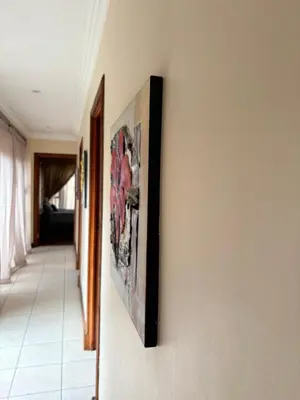 a hallway with paintings hanging on a wall at Lakeview Haven in Hartbeespoort