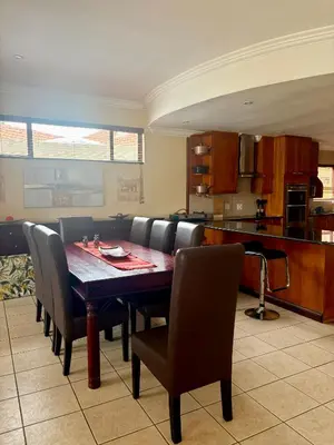 a kitchen and dining room with a table and chairs at Lakeview Haven in Hartbeespoort