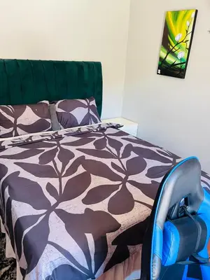 a bedroom with a bed with a black and white comforter at Kasi Retreat in Northam