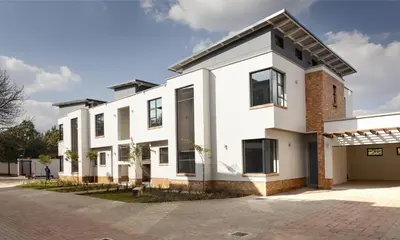 a large white house with a driveway at Perfect place for family in Pretoria