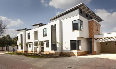 a large white house with a driveway at Perfect place for family in Pretoria