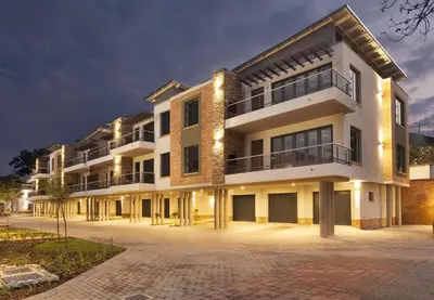 a large white building with lights on at Perfect place for family in Pretoria