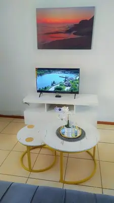 a living room with a tv and a coffee table at Yolipopsta stays in Kempton Park