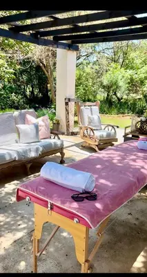 acovered patio with two beds and a table with a purple blanket at SPAat343 in Roodeplaat