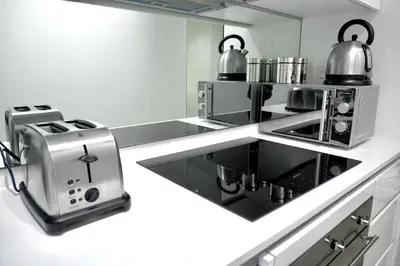 a kitchen with a stove and a toaster at Elipse Waterfall Luxe Executive Apartment in Midrand