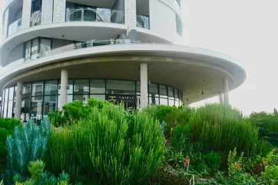 a building with a bunch of plants in front of it at Elipse Waterfall Luxe Executive Apartment in Midrand