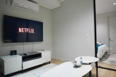 a living room with a television on a wall at Elipse Waterfall Luxe Executive Apartment in Midrand