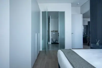 a bedroom with a white bed and a bathroom at Menlyn Pretoria 732 in Pretoria
