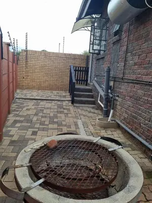 a brick building with a grill in a courtyard at Sunset Retreat in Polokwane