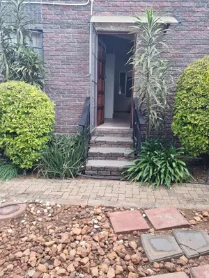 a brick house with stairs leading to a door at Sunset Retreat in Polokwane
