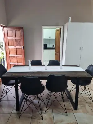 a table in a room with chairs around it at Sunset Retreat in Polokwane