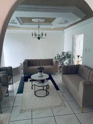 a living room with two couches and a table at Euphoria Escape in Midrand