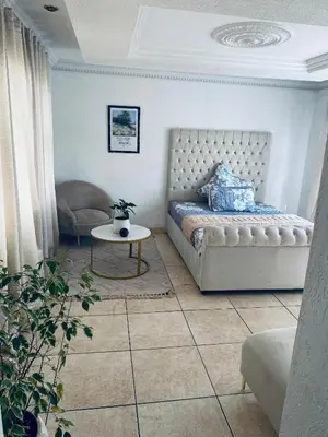 a bedroom with a bed and a table and a chair at Euphoria Escape in Midrand