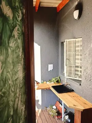 a kitchen with a table and a window in a room at Menatwork contractors accommodation in Nelspruit