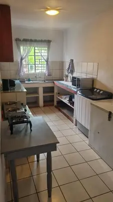 a kitchen with a table and a counter in it at Menatwork contractors accommodation in Nelspruit