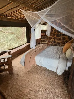 a bedroom with a bed in a tent at Aloe Lodge in Thabazimbi