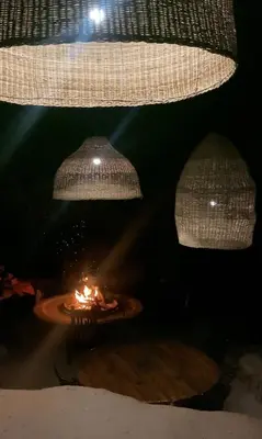 two chandeliers hanging over a table with a candle at Aloe Lodge in Thabazimbi