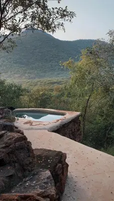 a swimming pool sitting on top of a mountain at Aloe Lodge in Thabazimbi