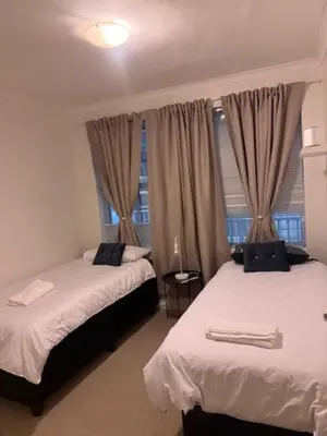 a bedroom with two beds and a window at The Oxford Haven