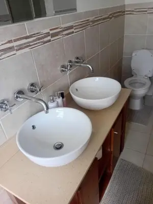 a bathroom with a white sink and a toilet at The Oxford Haven