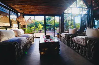 a living room with two couches and a table at La Dolce Vita Lodge in Hoedspruit