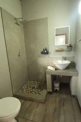 a bathroom with a shower and a sink and a toilet at La Dolce Vita Lodge in Hoedspruit