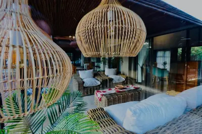 a living room with two hanging chandeliers and couches at La Dolce Vita Lodge in Hoedspruit