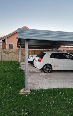 two cars parked in a parking lot with a garage at Ermelo Executive Rooms in Ermelo
