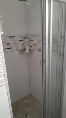 a shower with a glass door in a bathroom at Ermelo Executive Rooms in Ermelo