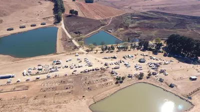 an aerial view of a parking lot next to two reservoirs at Elandskloof Trout Farm in Dullstroom